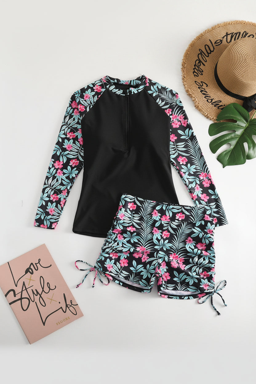Active women's tropical print two-piece rashguard swimsuit for surfing, paddleboarding, or beach sports.