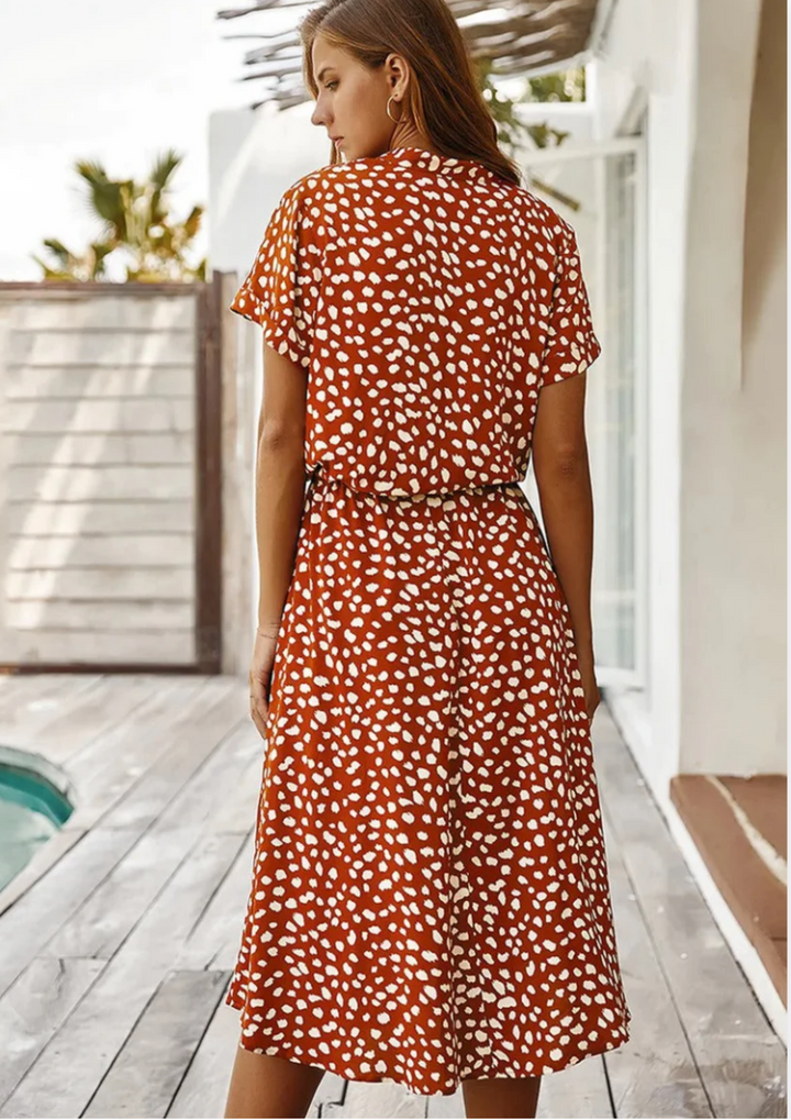 Sophisticated women's spotted midi dress with a classic button-down front and stylish flutter sleeves.