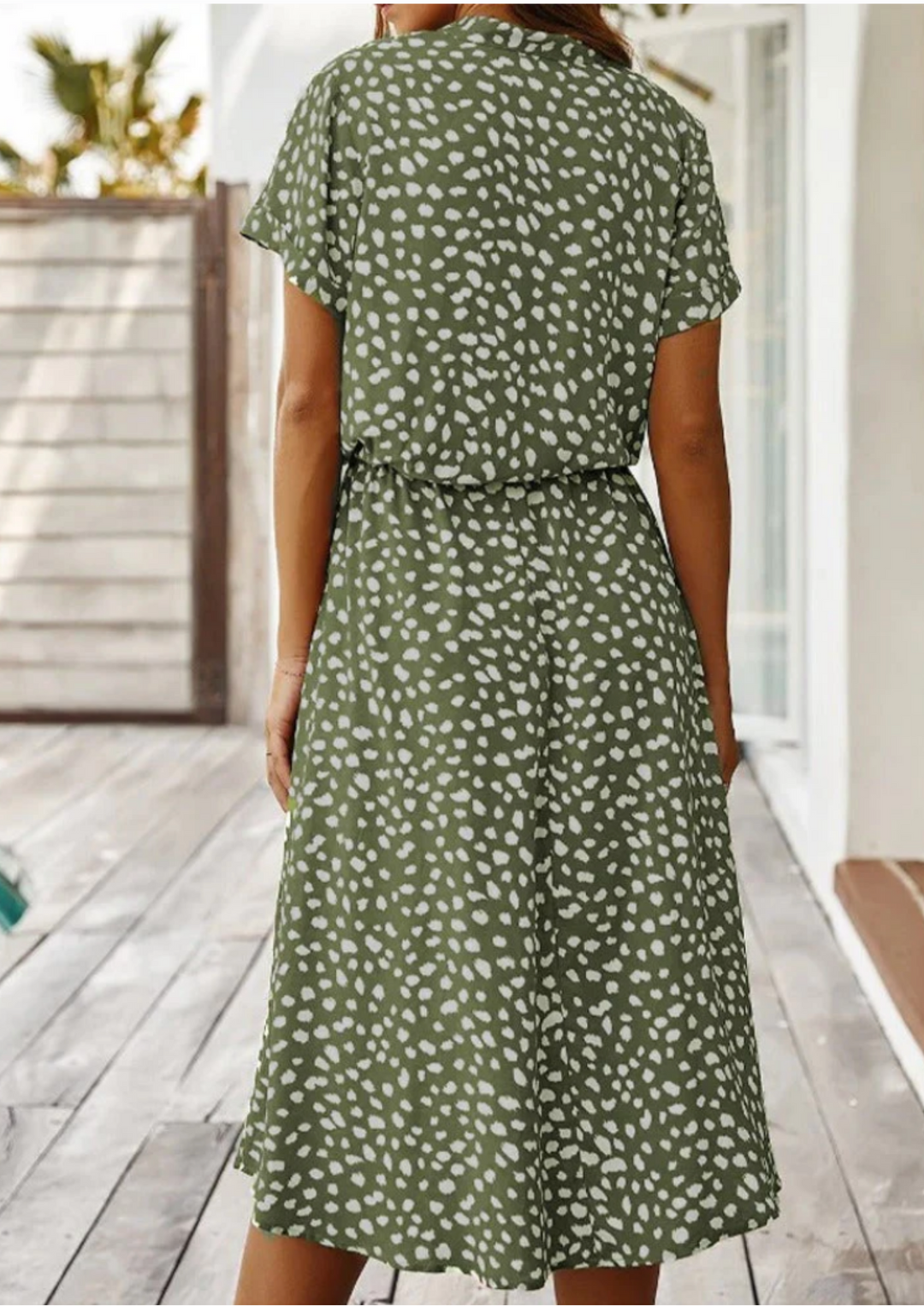 Graceful spotted midi dress for women, featuring a full button-down closure and soft flutter sleeves.