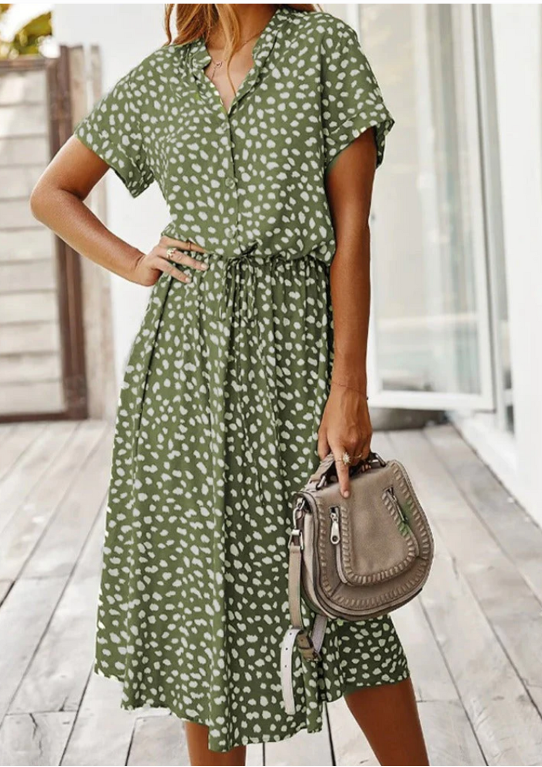 Chic women's spotted print midi dress featuring a full button-down front and flutter sleeves.