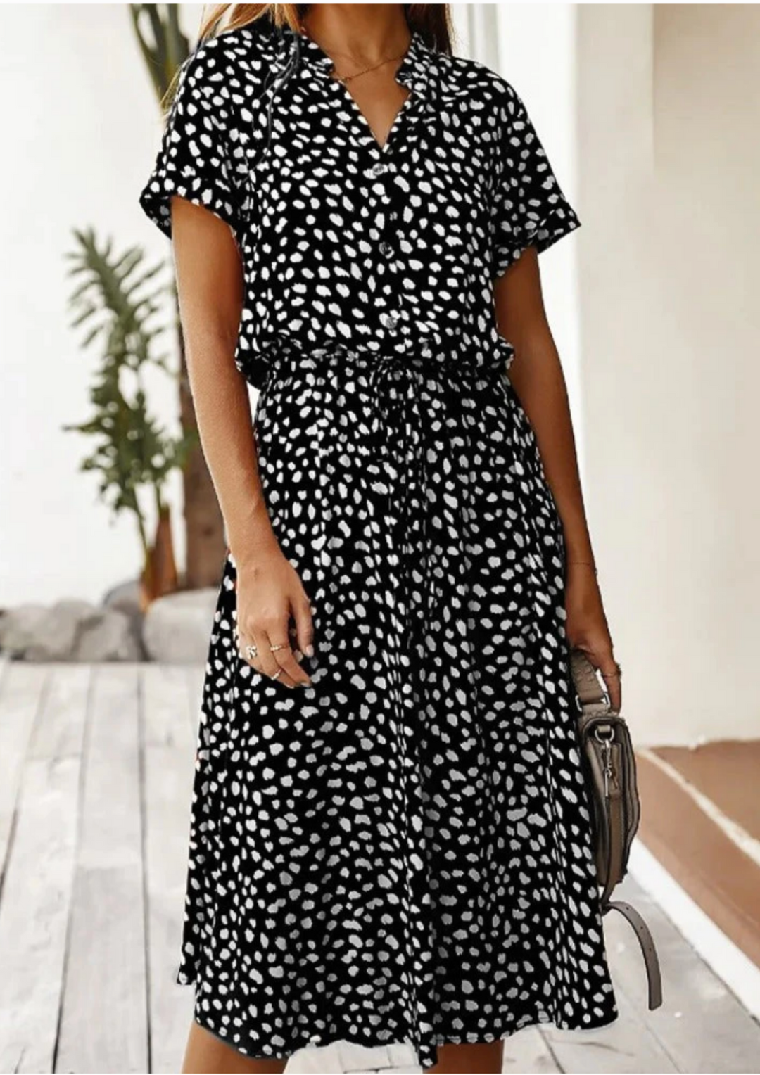 Stylish women's fashion midi dress with a playful spotted pattern and comfortable flutter sleeves.