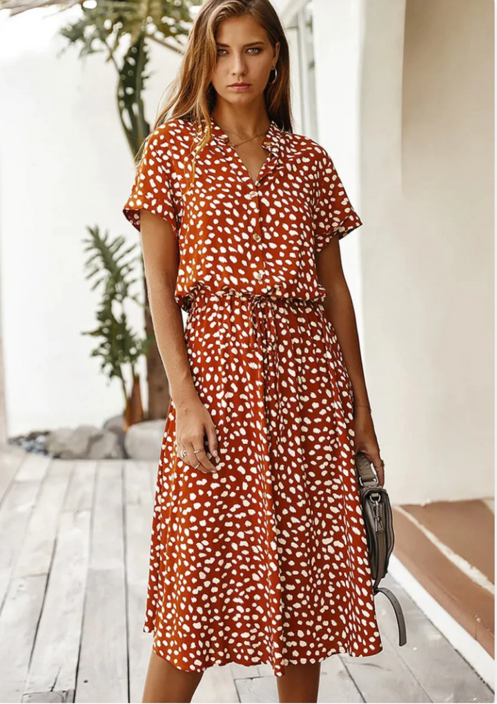Casual women's button-down midi dress with a relaxed fit, spotted print, and charming flutter sleeves.
