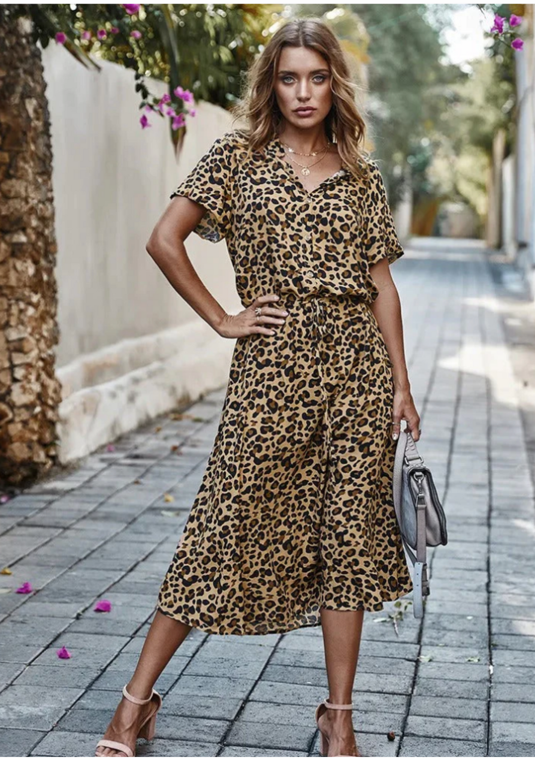 Relaxed fit women's spotted button-down midi dress, perfect for casual wear with its flutter sleeves.
