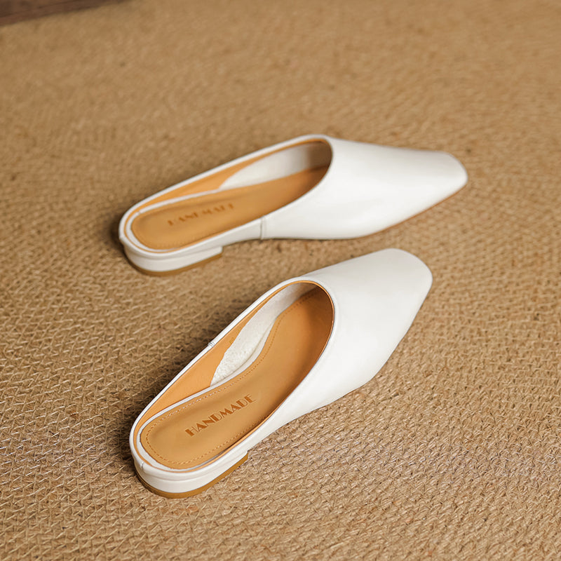 Sleek white square-toe block heel mules for women. Comfortable, chic slip-on footwear for a fresh, modern style.