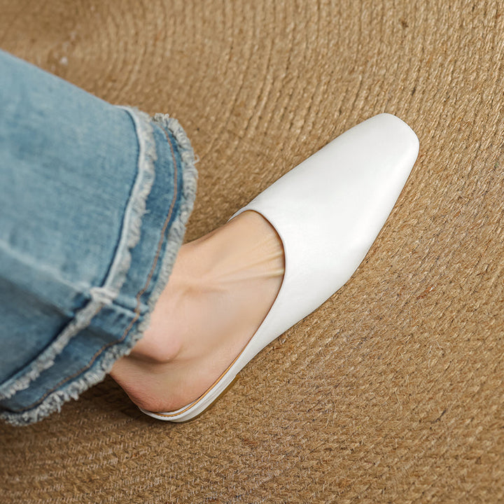 Close-up of women's square-toe block heel mules, showcasing modern design & comfortable slip-on style.