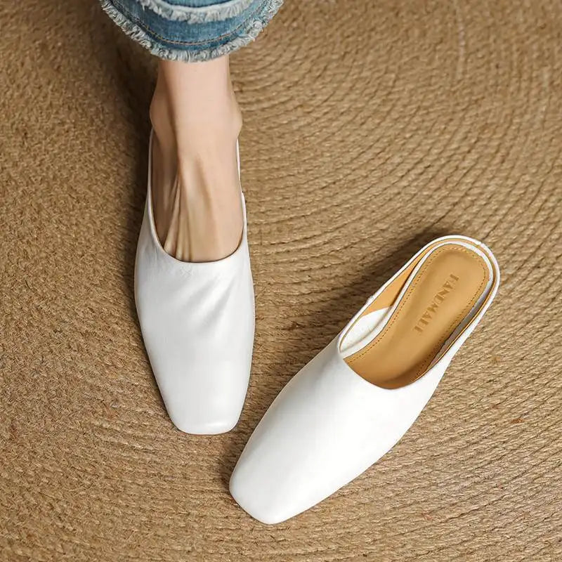 Classic black square-toe block heel mules. Women's comfortable slip-on shoes, ideal for sophisticated everyday wear.