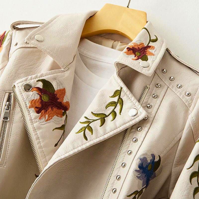 Trendy women's jacket with striking studded details and delicate floral embroidery, ideal for edgy outerwear.