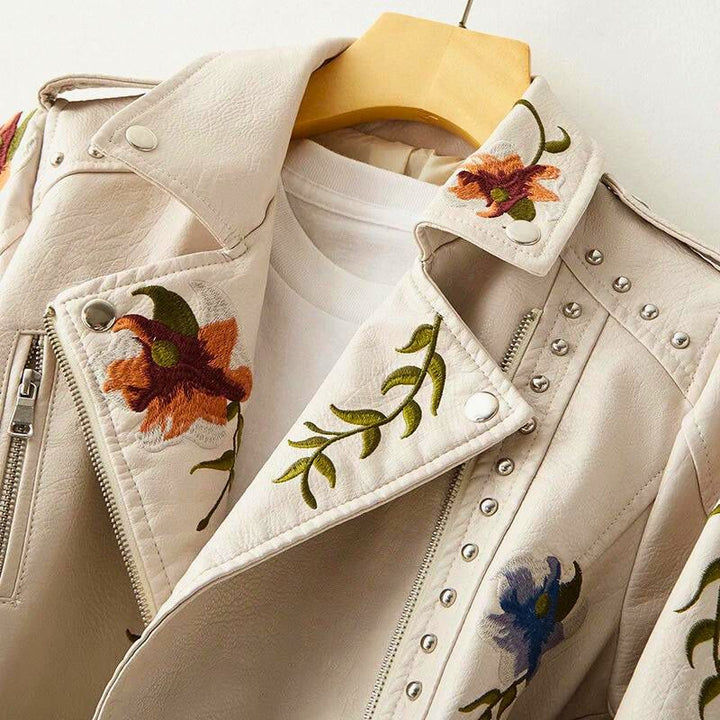 Trendy women's jacket with striking studded details and delicate floral embroidery, ideal for edgy outerwear.