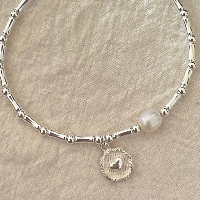 Sterling silver bamboo bead knot bracelet for women, adjustable and hypoallergenic, showcasing fine craftsmanship.