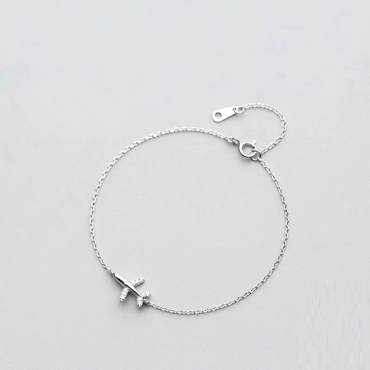 Women's sterling silver bracelet with a detailed plane charm, perfect for travel enthusiasts and adventure style.