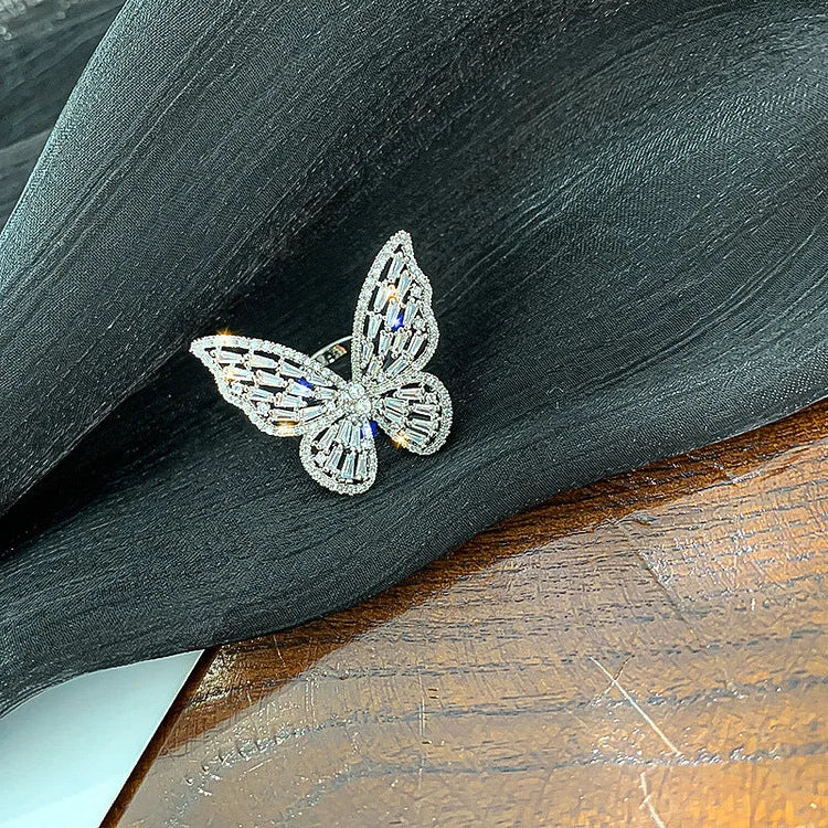 Symbolic butterfly ring with shimmering crystals on a sterling silver band. Beautiful women's jewelry, a unique fashion statement.