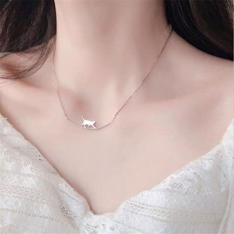 Sterling silver climbing cat pendant necklace, a whimsical animal-themed jewelry gift for women.