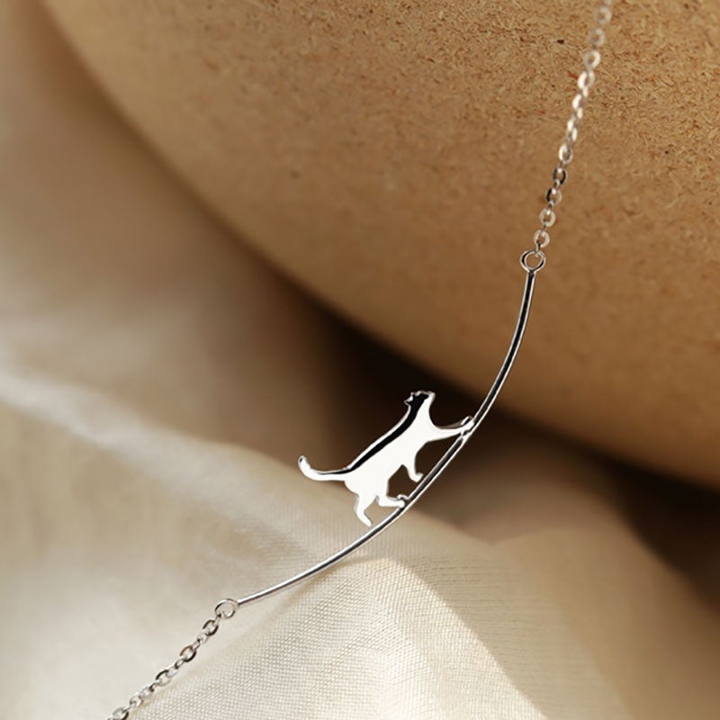 Elegant sterling silver climbing cat necklace, a beautiful feline pendant for everyday wear.