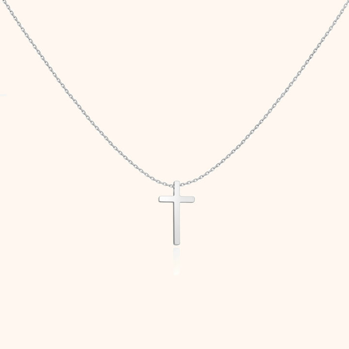 Versatile women's sterling silver cross necklace with a polished pendant. Everyday spiritual jewelry fashion.