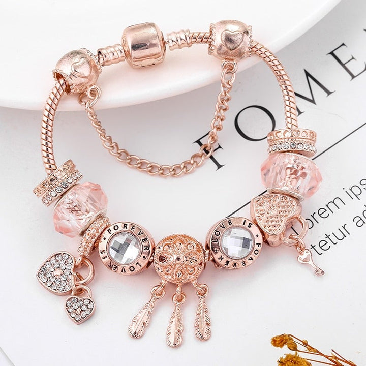 Women's sterling silver dreamcatcher charm bracelet with intricate feather details, perfect as a symbolic jewelry gift.