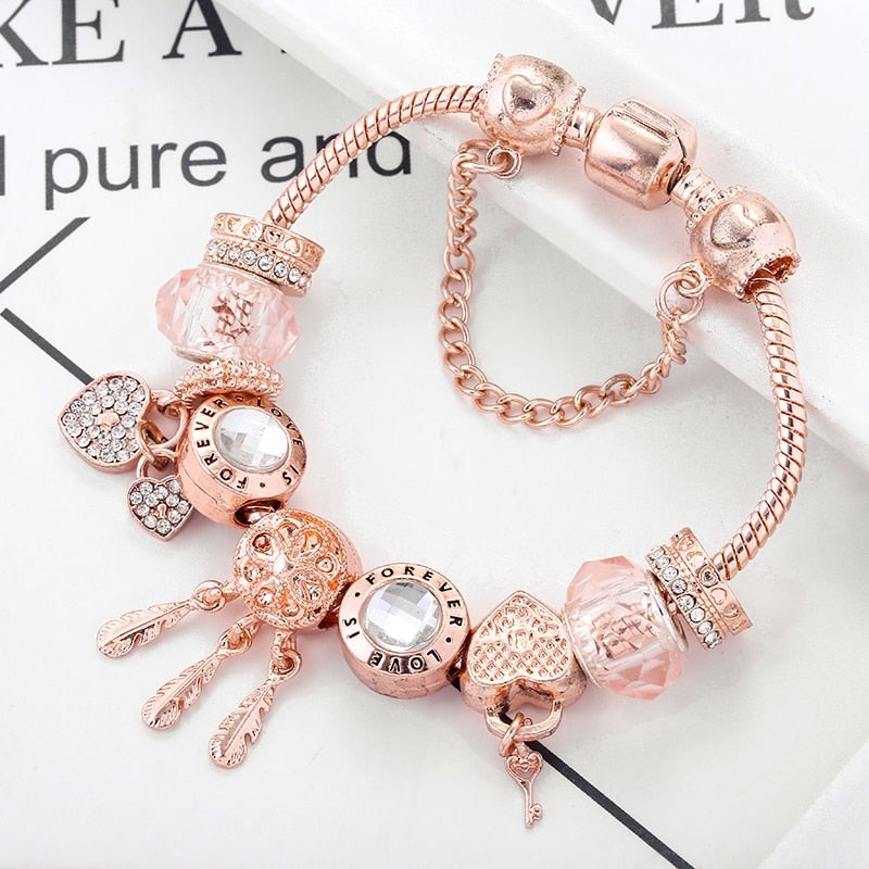 Pink sterling silver dreamcatcher charm bracelet for women, a spiritual and elegant piece of symbolic jewelry.