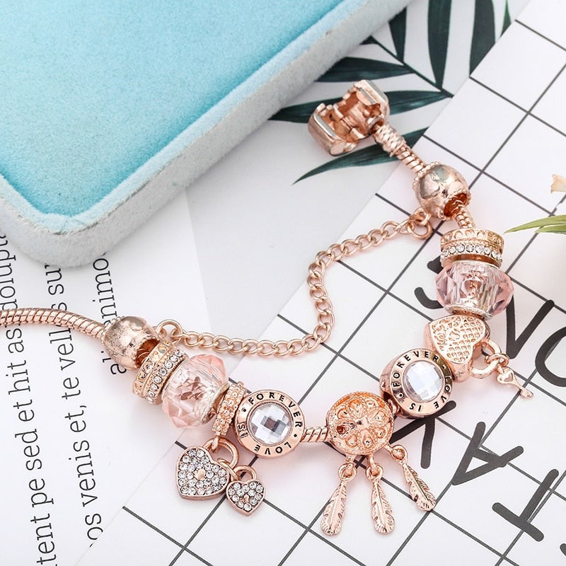 Stylish women's sterling silver dreamcatcher charm bracelet, featuring delicate pink accents, ideal fashion jewelry.