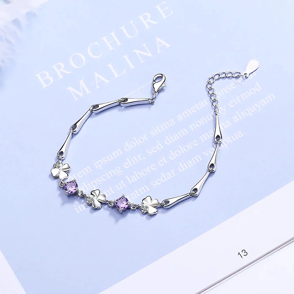 Women's sterling silver four-leaf clover charm bracelet, an elegant and lucky good luck jewelry piece.