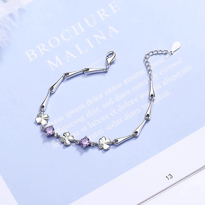 Women's sterling silver four-leaf clover charm bracelet, an elegant and lucky good luck jewelry piece.