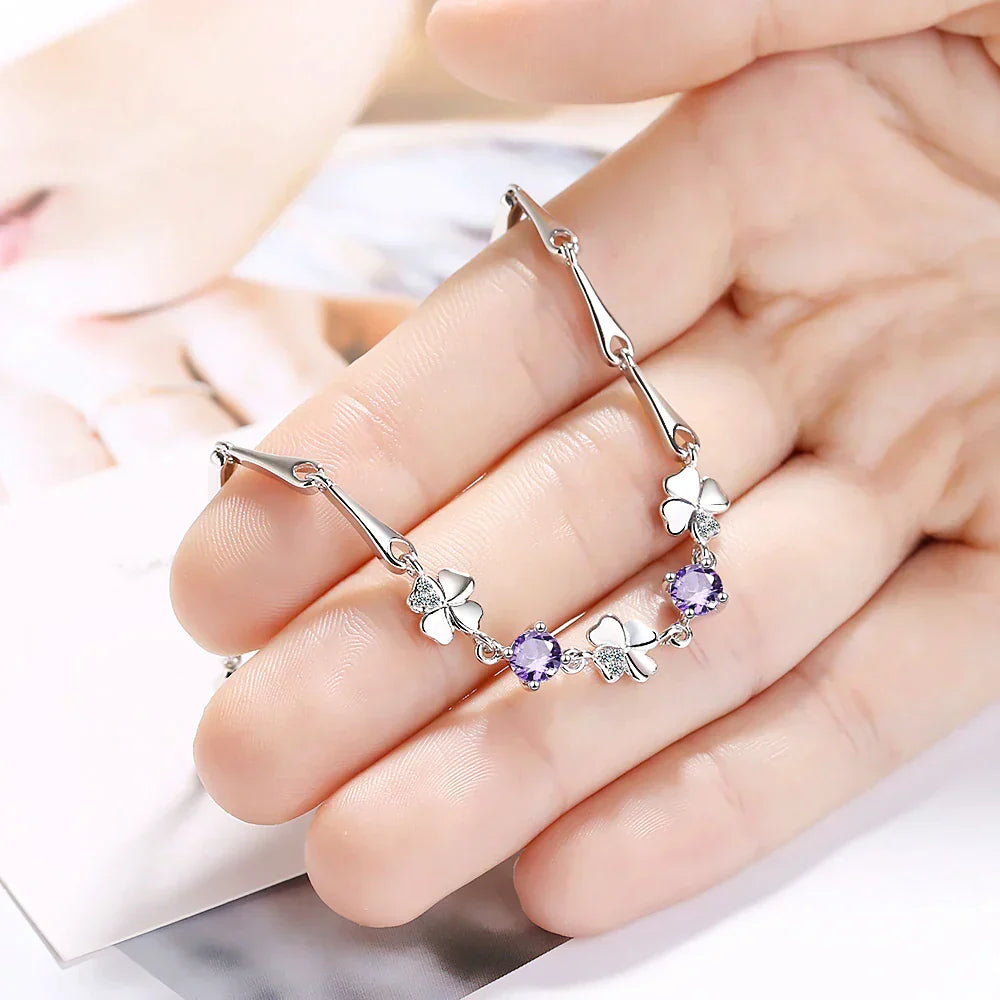 Adjustable sterling silver bracelet for women, featuring a delicate four-leaf clover charm for good luck.