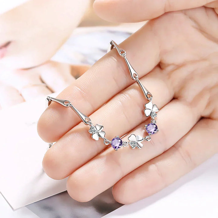 Adjustable sterling silver bracelet for women, featuring a delicate four-leaf clover charm for good luck.