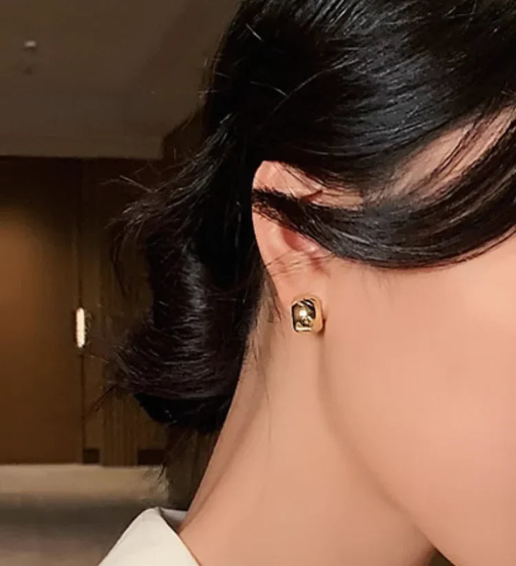 Women's sterling silver hoop earrings with gold finish, blending subtle elegance & bold modern design for everyday wear.