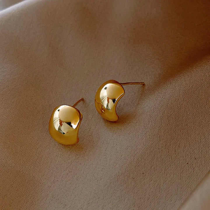 Modern women's sterling silver hoop earrings, featuring a gold finish for a stylish, versatile subtle & bold look.