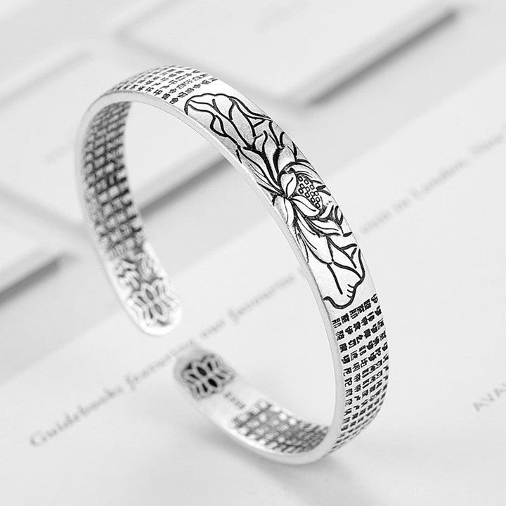 Delicate sterling silver lotus bracelet, a serene and adjustable piece of women's jewelry.