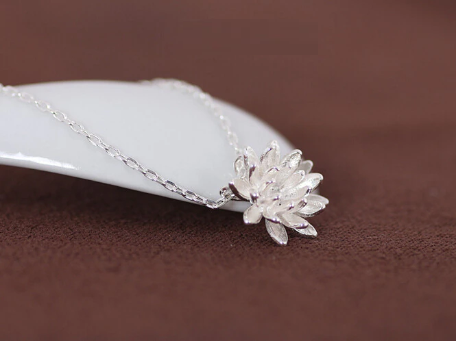 Detailed sterling silver lotus flower pendant on a delicate chain. Elegant women's necklace, nature-inspired silver jewelry.