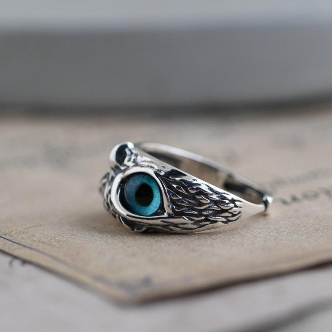Adjustable silver owl ring featuring a shimmering opal charm, perfect for women. A unique animal jewelry piece.