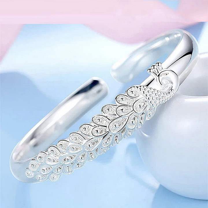 Elegant women's sterling silver bracelet featuring a beautiful peacock charm. A lovely gift for her.