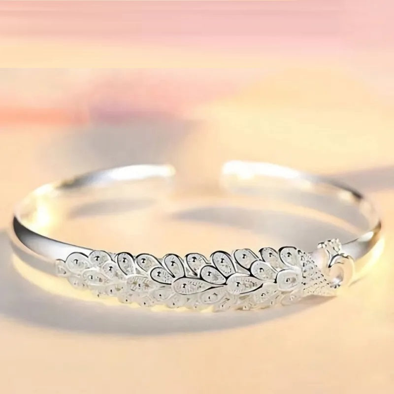 Sterling silver peacock charm bracelet, a timeless piece of women's jewelry, elegant and eye-catching.