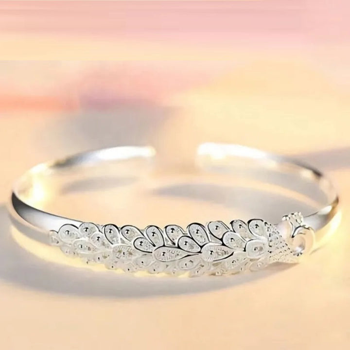 Sterling silver peacock charm bracelet, a timeless piece of women's jewelry, elegant and eye-catching.