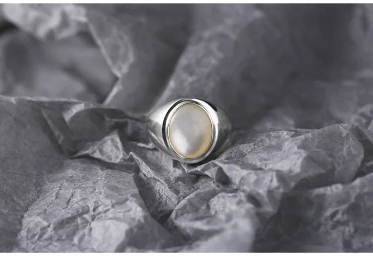 Radiant mother of pearl gemstone in a women's sterling silver ring, ideal for gifting.