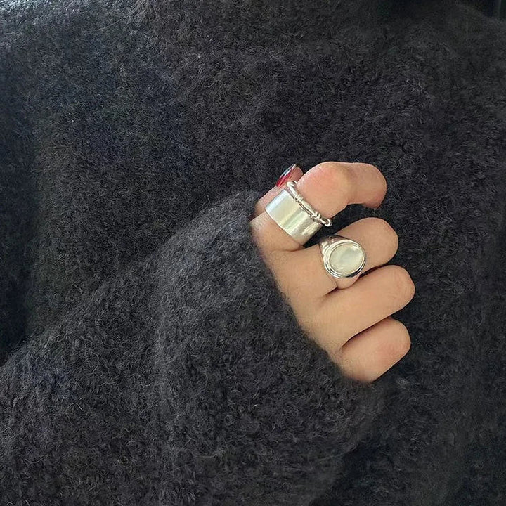 Close-up: Captivating mother of pearl stone in a women's sterling silver adjustable ring.