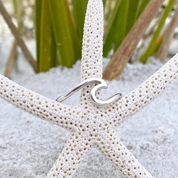 Detailed sterling silver wave ring for women, showcasing a beautiful, smooth ocean wave design.