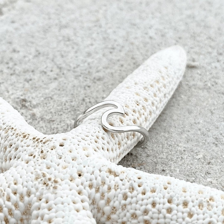 Stunning women's sterling silver ring featuring a gracefully sculpted sea wave, ideal nature-inspired jewelry.