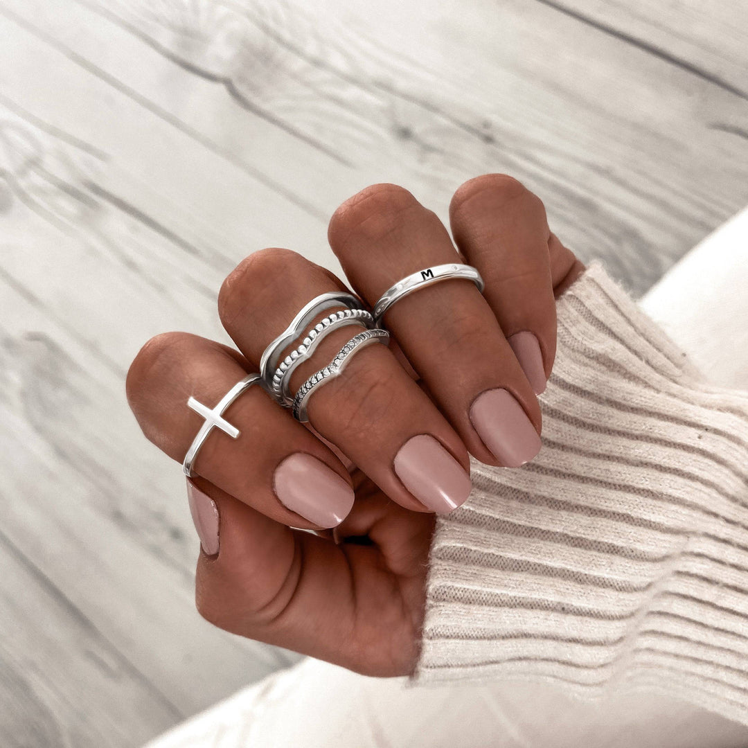 Trendy women's sterling silver cross ring, perfect for a fashionable spiritual statement.