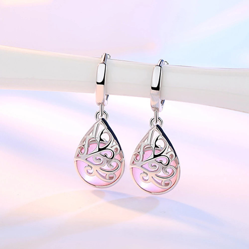 Intricate sterling silver Tree of Life dangle earrings for women. Elegant, symbolic jewelry, ideal for gifting.