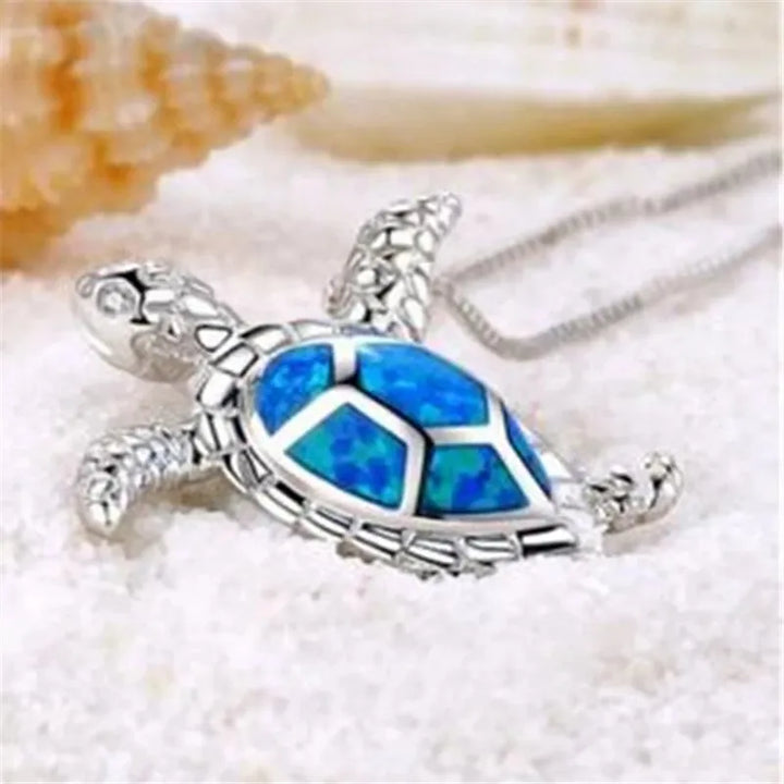 Woman wearing a sterling silver turtle necklace, a meaningful gift representing wisdom & longevity. Elegant pendant.
