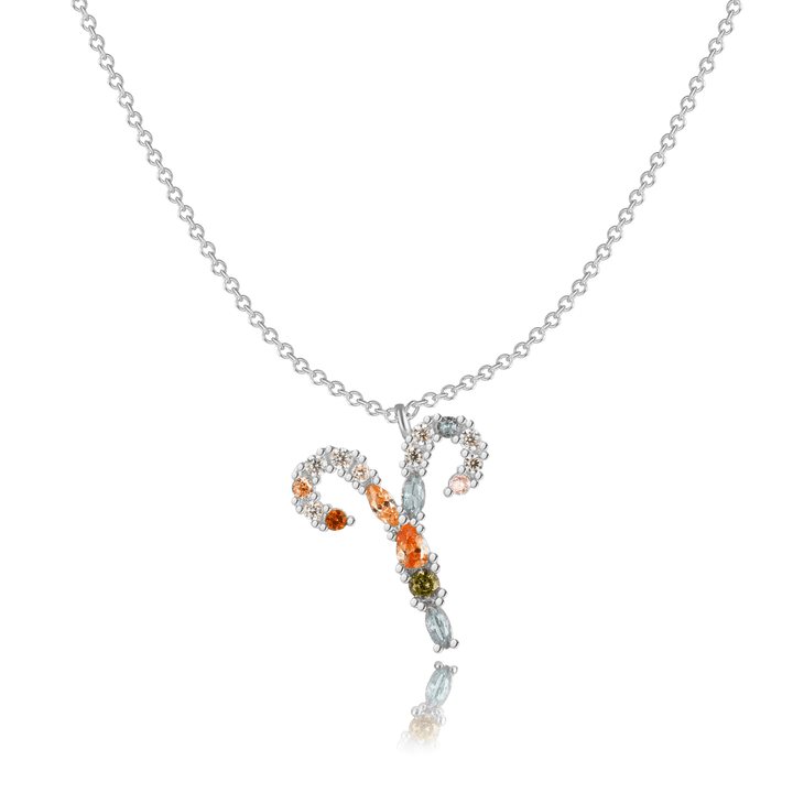 Layered sterling silver celestial jewelry, zodiac charm.
