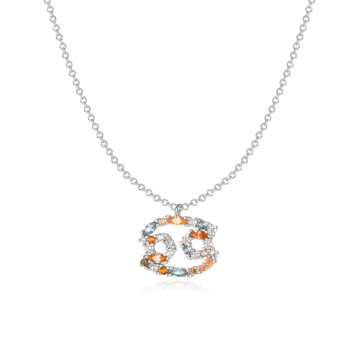 Sterling silver zodiac charm on a woman's neckline.