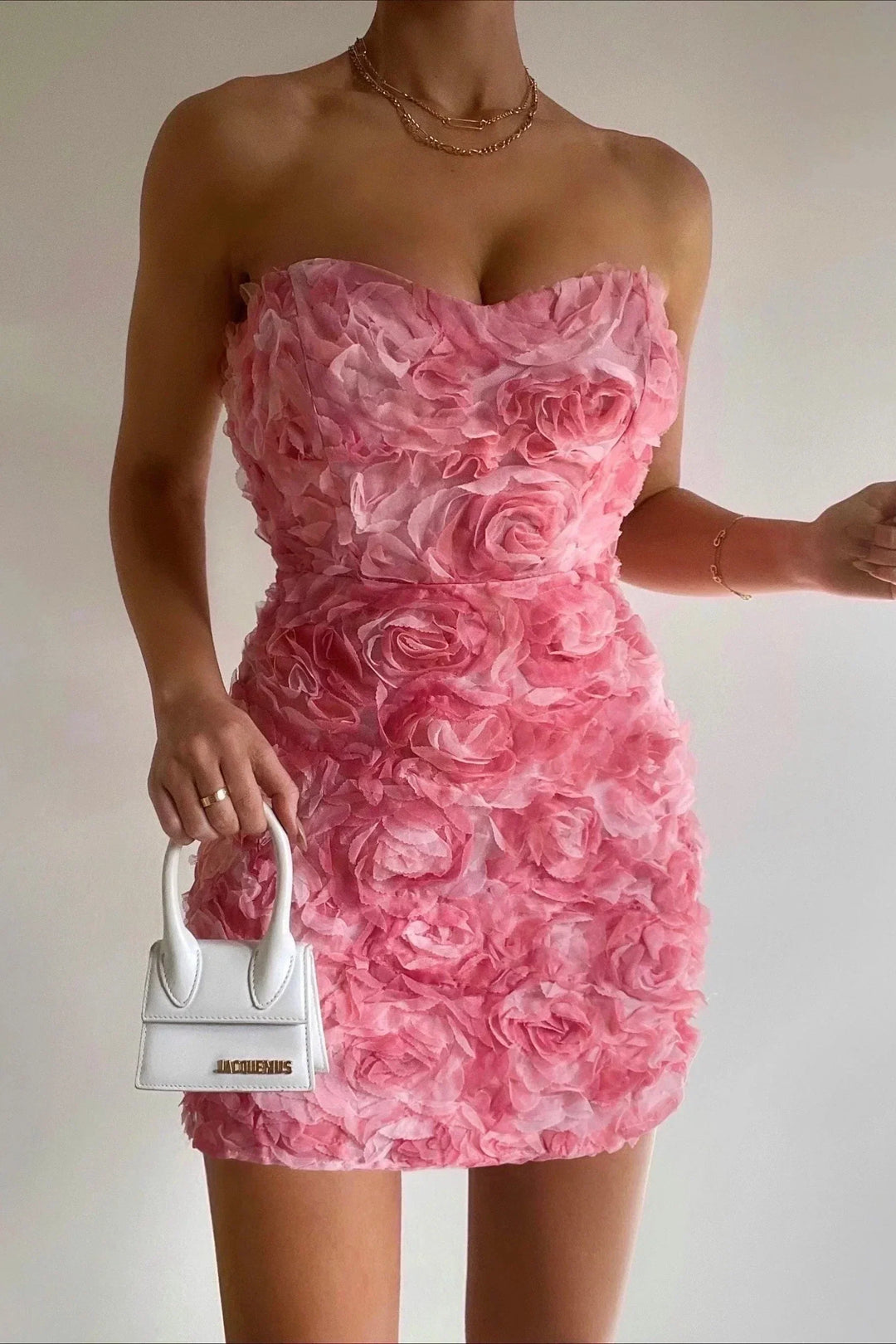 Women's strapless boho floral summer dress with a vibrant pink print. Trendy and elegant for vacation outfits.