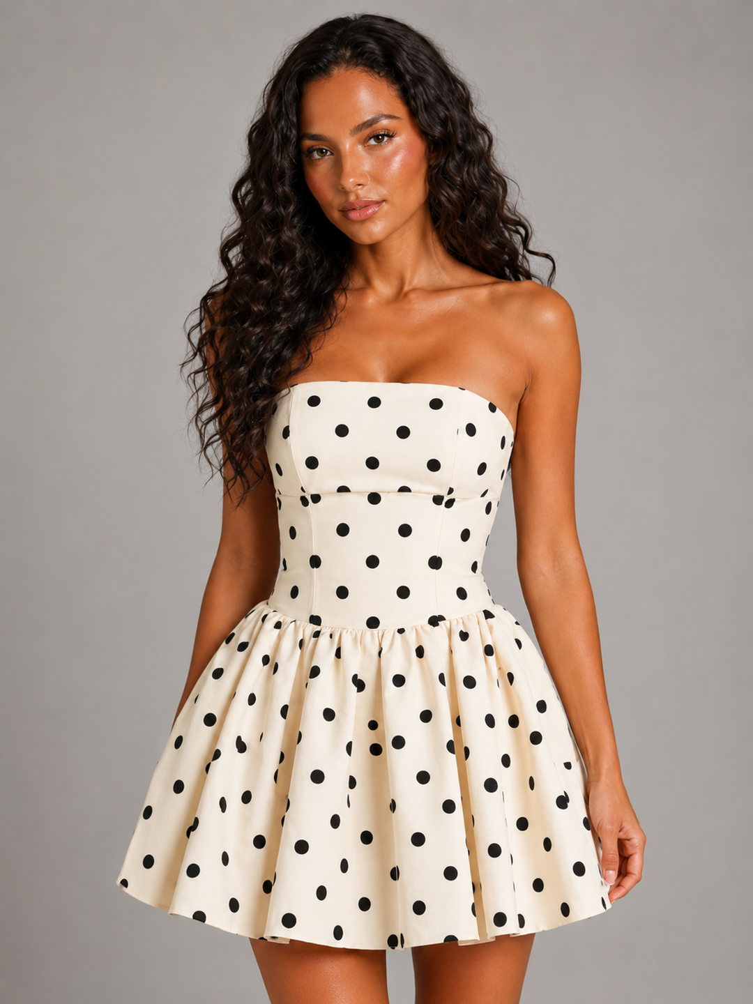 Stylish women's strapless polka dot homecoming dress featuring a fitted bodice and a short flared skirt.