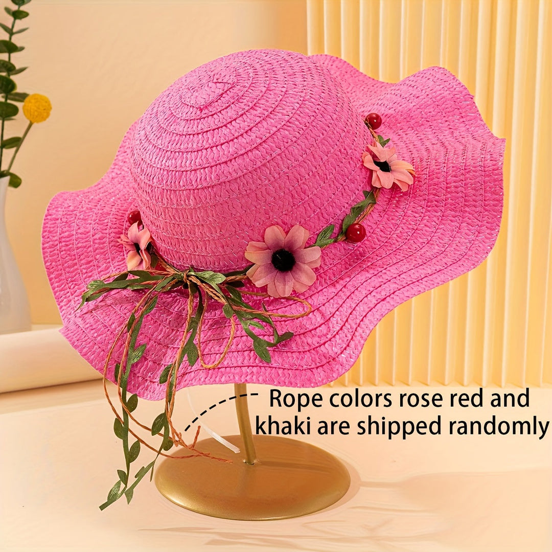 Close-up of women's straw sun hat showing intricate floral & fruit embellishments.