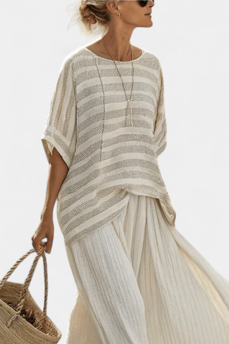 Two-piece women's striped batwing top & flowing maxi skirt set, featuring a comfortable, stylish design.