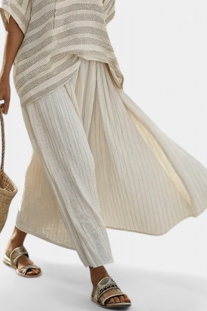 Elegant women's striped batwing top & flowy maxi skirt set for a stylish two-piece summer vacation outfit.