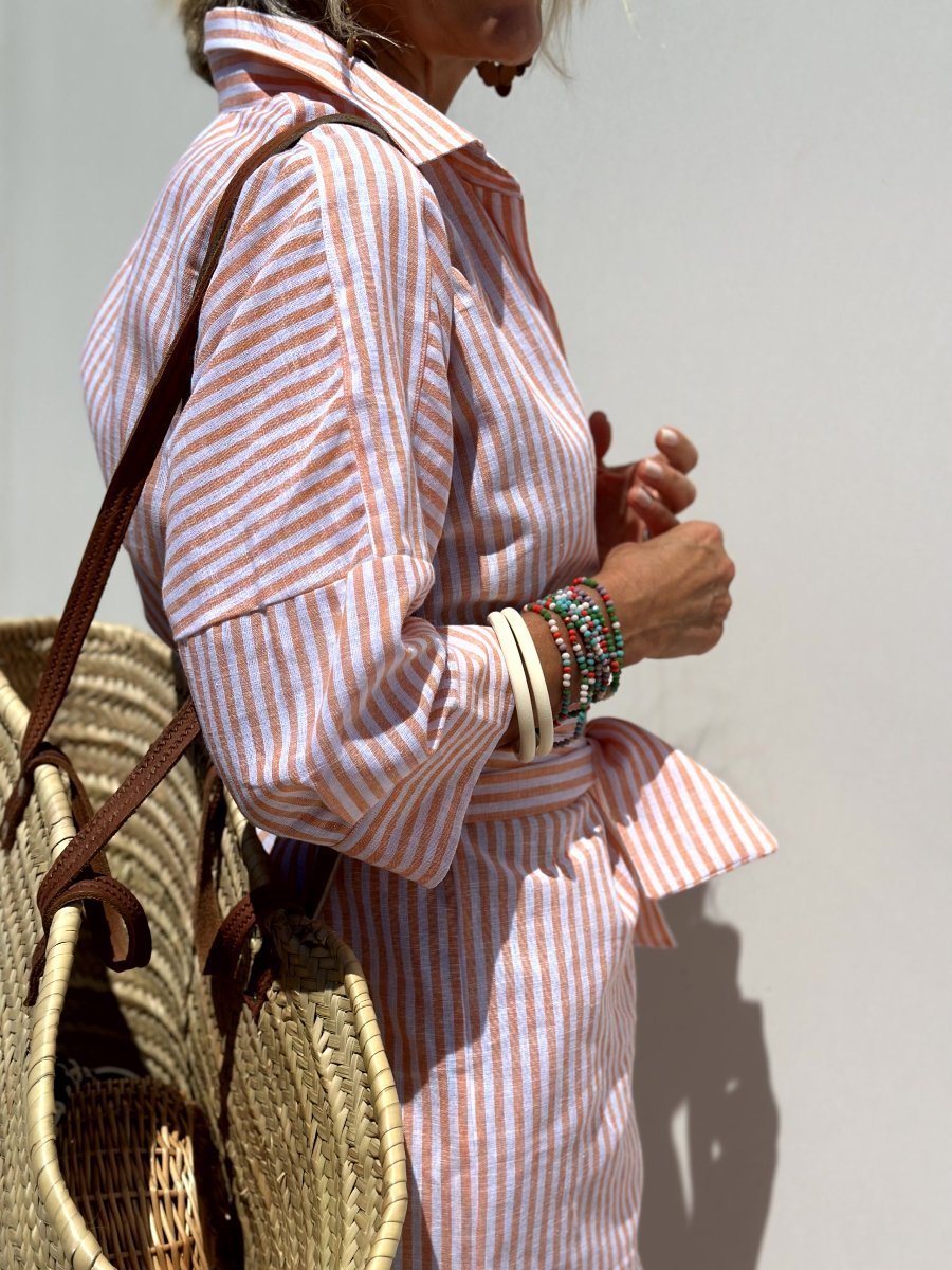 Casual women's striped midi shirt dress with a full button front, a versatile choice for vacation outfits.