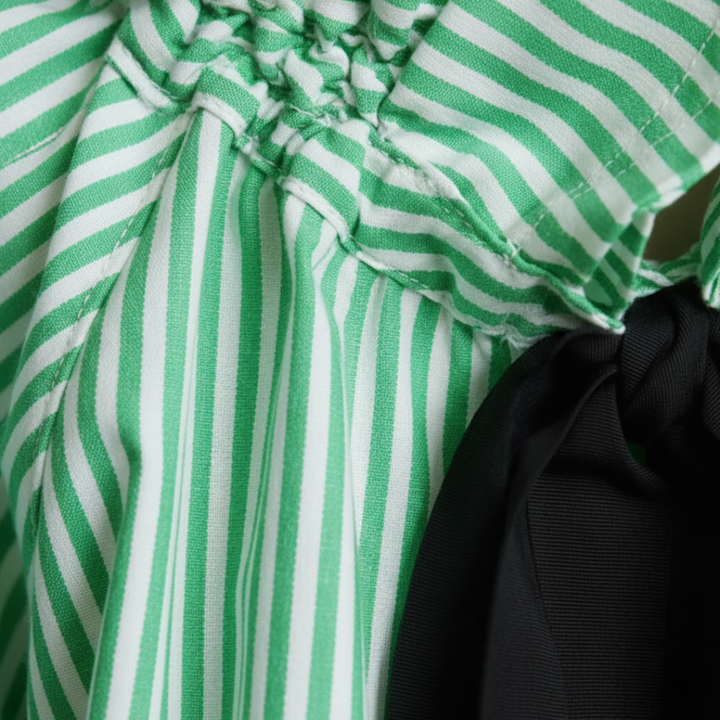 Elegant striped women's blouse with a fashionable ruffle neckline and chic balloon sleeves.