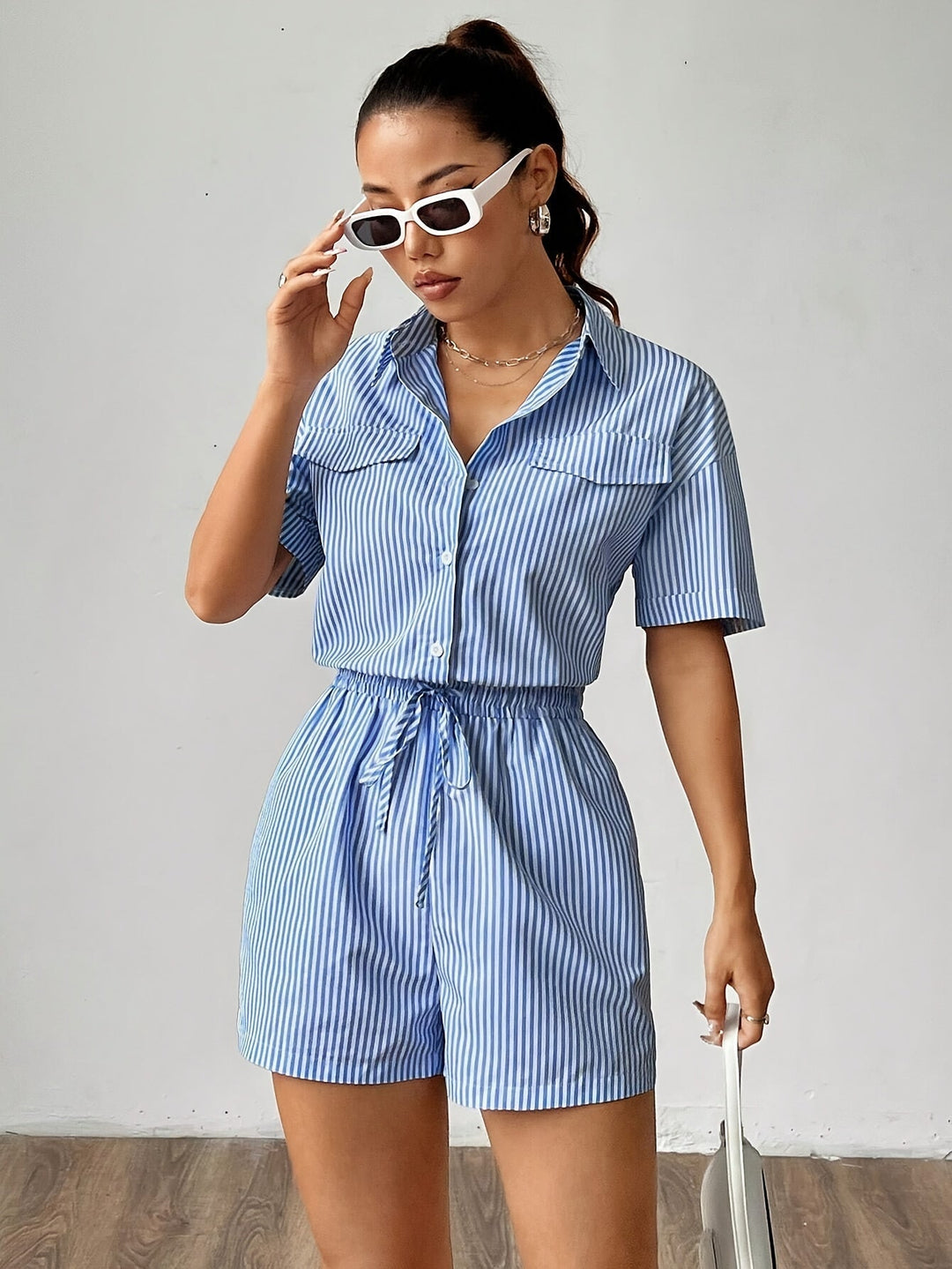 Fashionable women's polyester jumpsuit, striped, with short sleeves and elastic waist for summer.